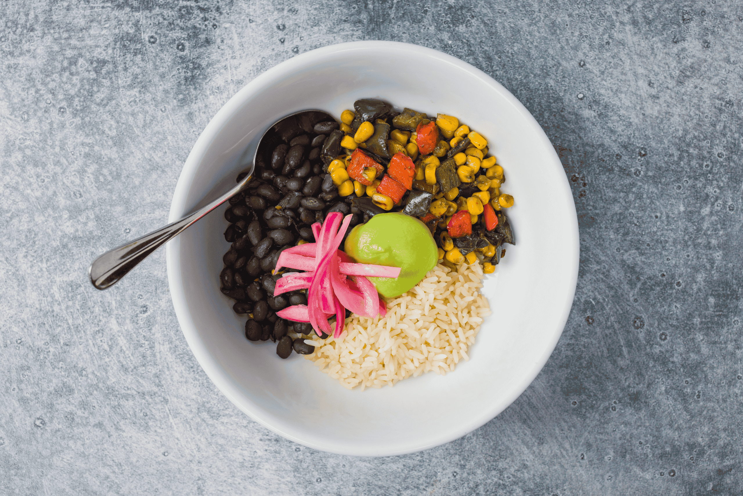 Black Bean Burrito Bowl with Avocado Crema, Corn, and Peppers
